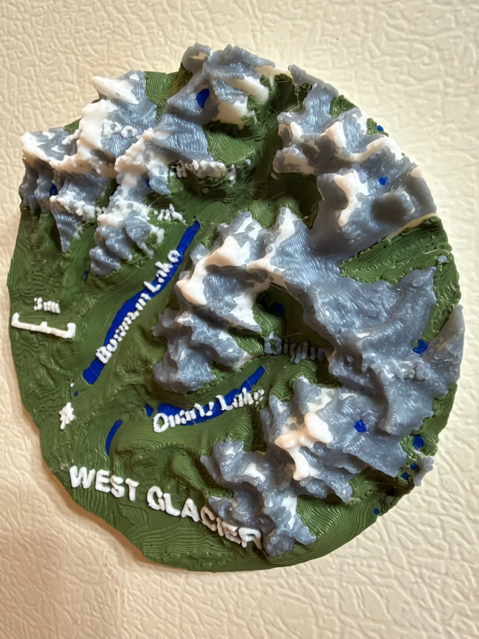 West Glacier fridge magnet with raised mountain peaks and blue Bowman and Quartz lakes