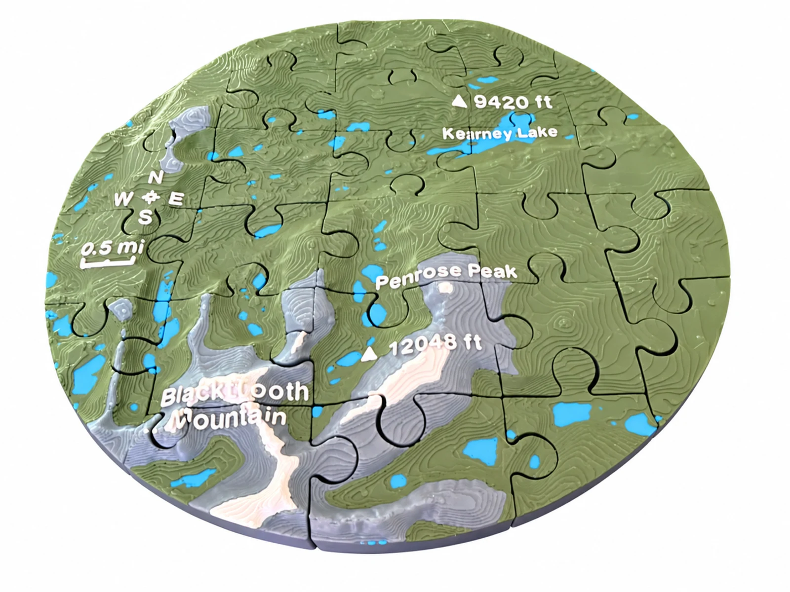 Finished round mountain topographic puzzle with Kearney Lake and Penrose Peak on a white background